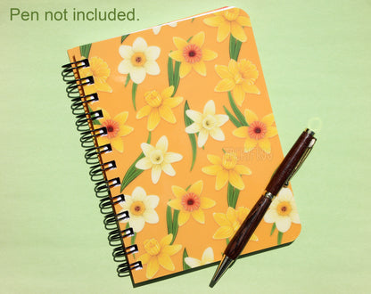 A yellow daffodils mini notebook. The text in the upper left corner reads "Pen not included".
