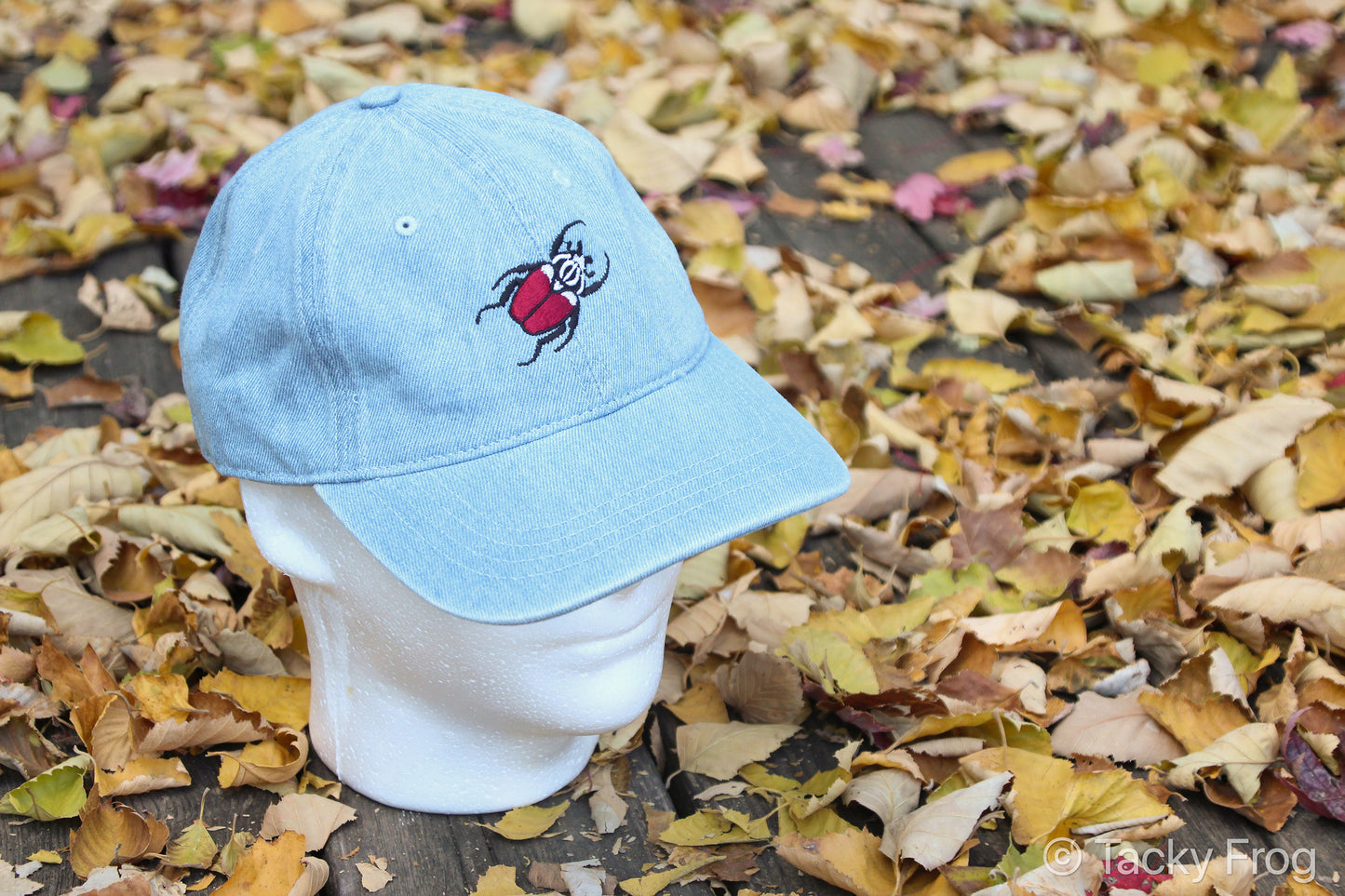 A light blue denim hat with a Goliath beetle on it.