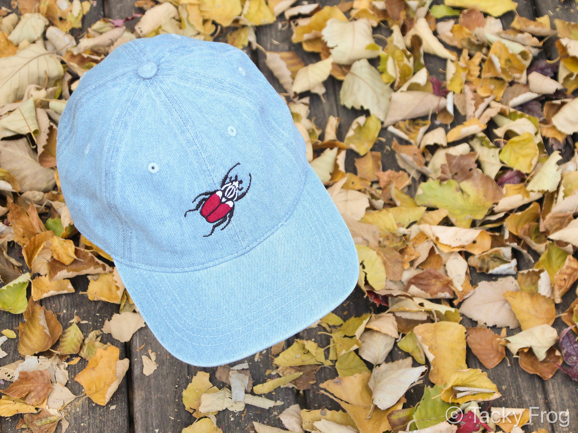 A light blue denim hat with a Goliath beetle on it.