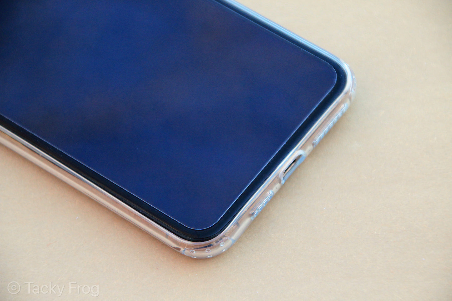 The clear phone case shown on an iPhone, screen-side up.