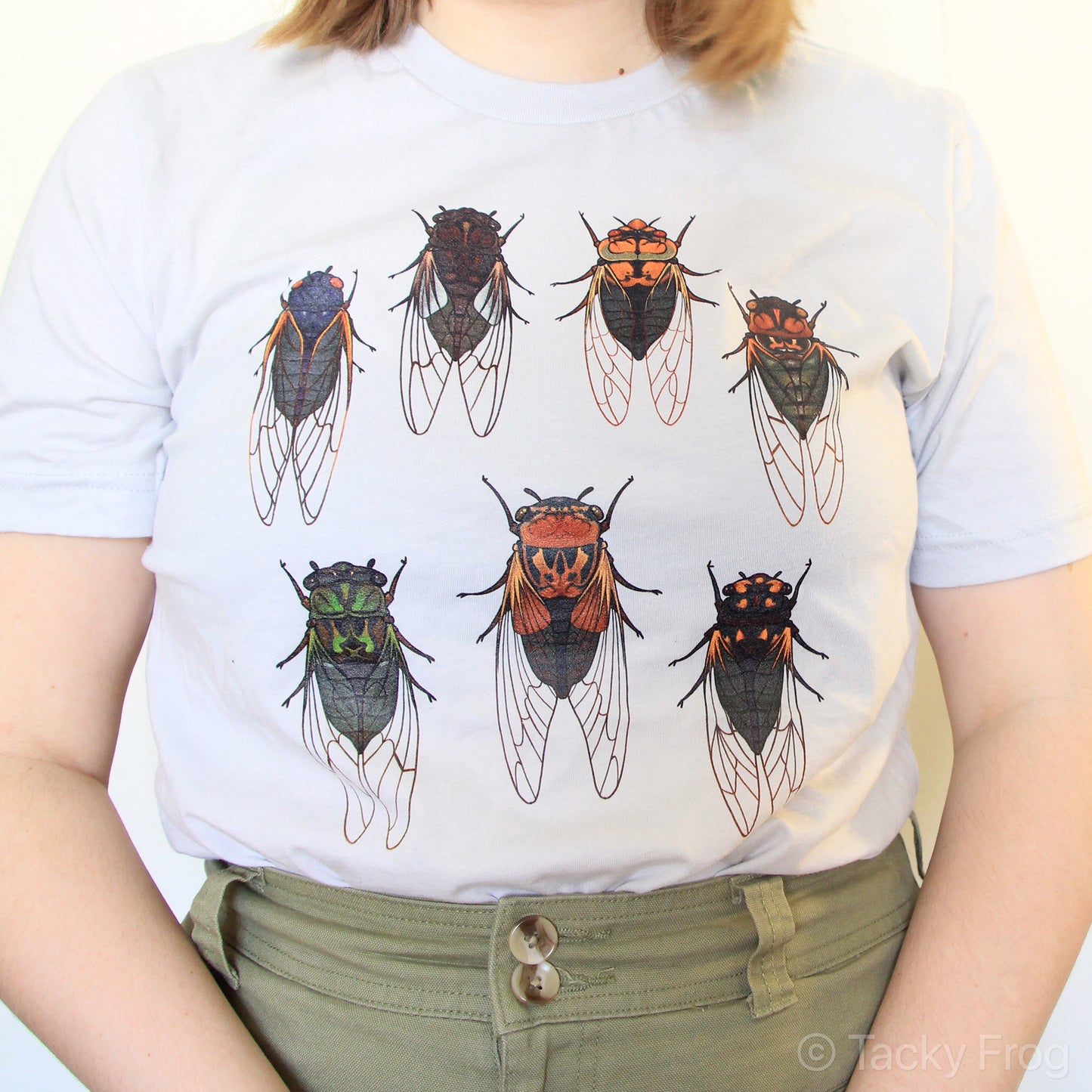 A silver-colored t-shirt with cicadas on it.