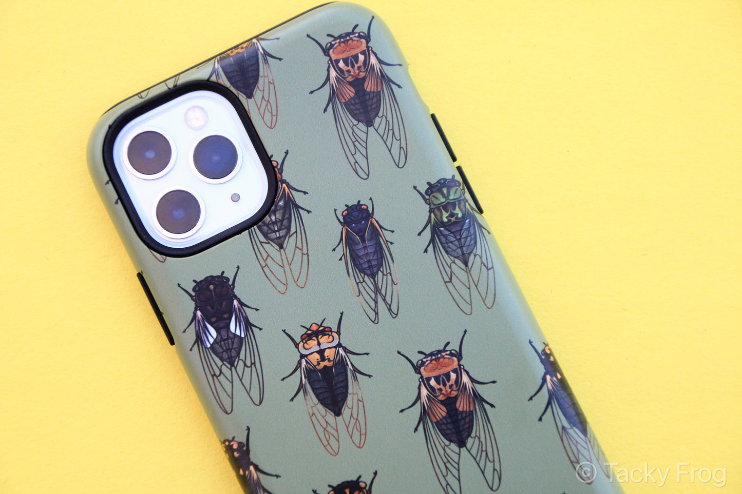 A green phone case with a cicada pattern on it.