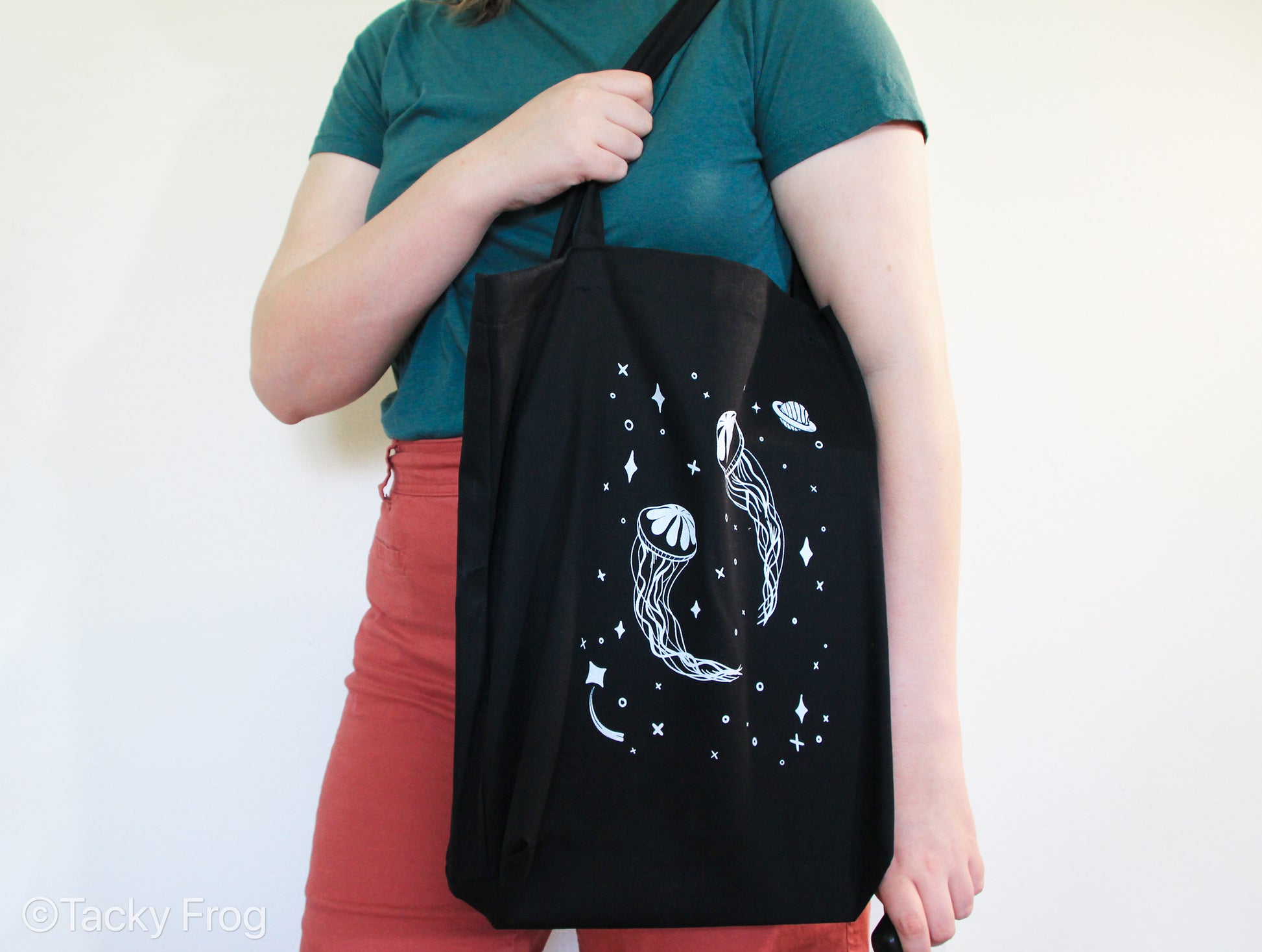 A woman carrying the space jellyfish tote bag.