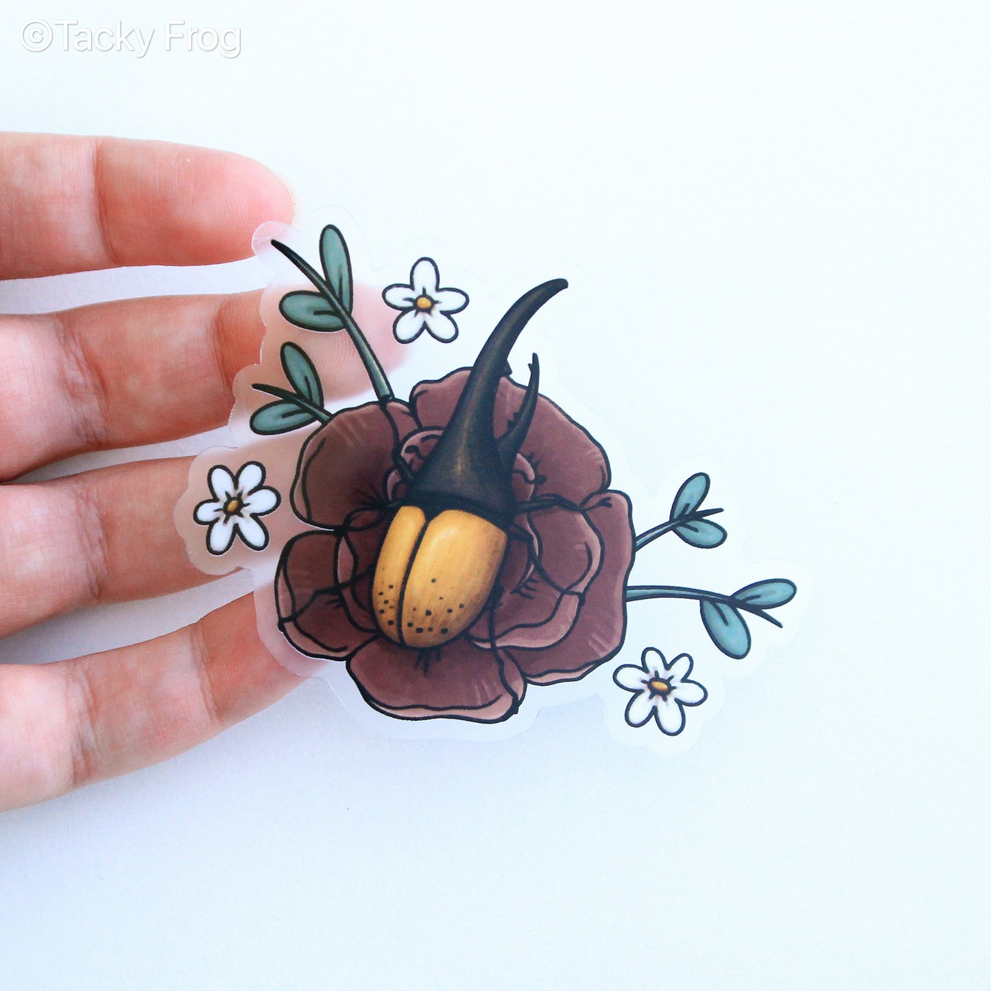 A clear vinyl sticker depicting a Hercules beetle perched on a peony flower.