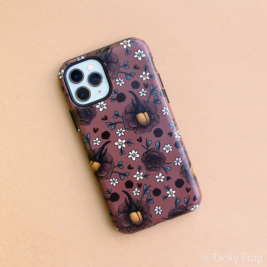 A burgundy-colored phone case featuring a pattern of Hercules beetles, peonies, and daisies.