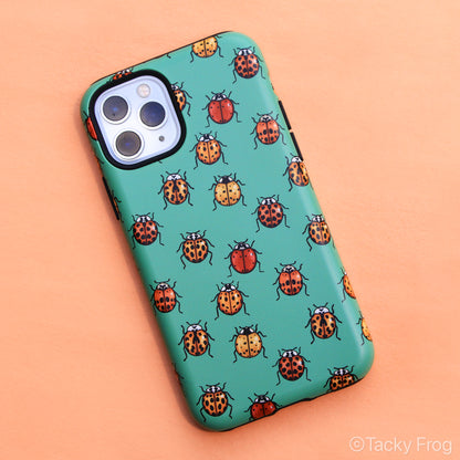 A sea-foam green-colored phone case featuring a pattern of ladybugs on it.