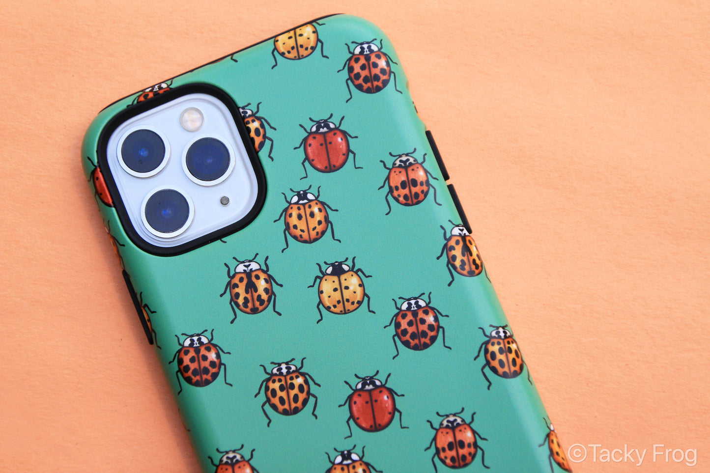 Close up of the ladybugs on the green phone case.