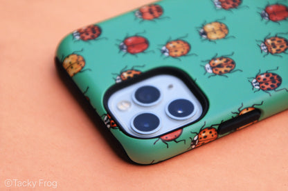 The upper half of the ladybug phone case. The phone case is dual-layered, with the inner layer being solid black.