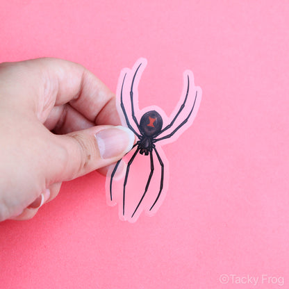 A clear vinyl sticker of a black widow spider.