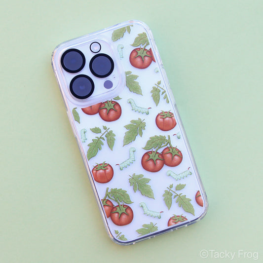 A clear phone case, shown on an iPhone, featuring a pattern of tomatoes, leaves, and caterpillars.