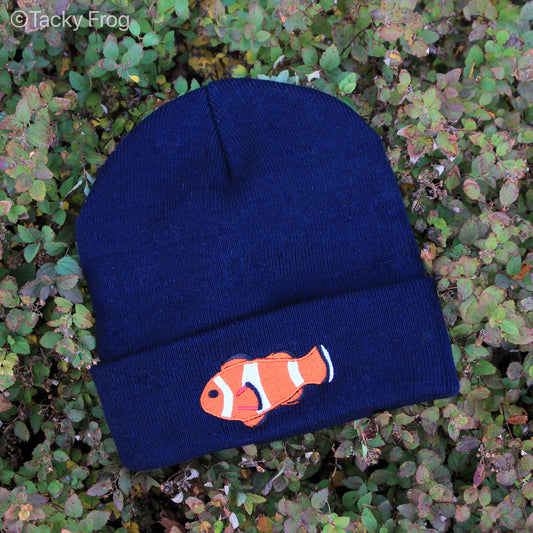 A navy-colored beanie with a clownfish embroidered on it.