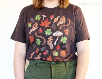 A better view of the outdoor-inspired t-shirt. The design on the shirt includes snails, mushrooms, ladybugs, leaves, acorns, millipedes, and more.