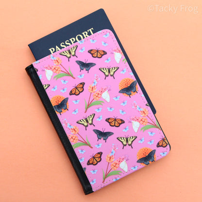 The butterfly garden-inspired passport wallet against an orange background.