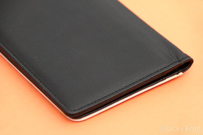 The back cover of the passport wallet which is solid black.