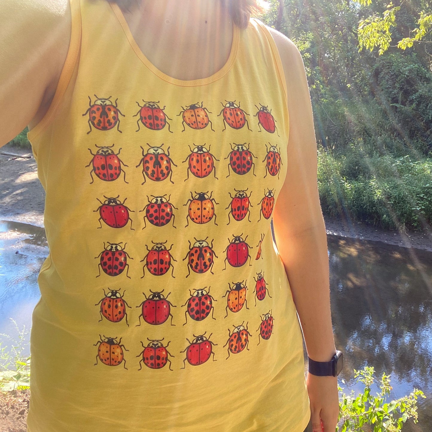 A closer view of the ladybug unisex tank top.