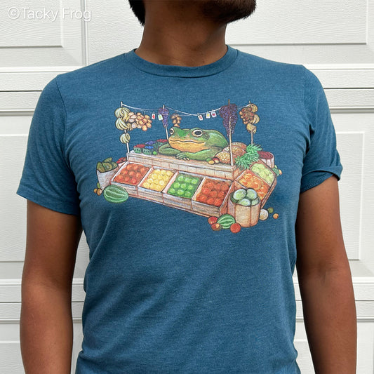 A Heather Deep Teal-colored t-shirt featuring a design that depicts a frog operating a fruit stand.