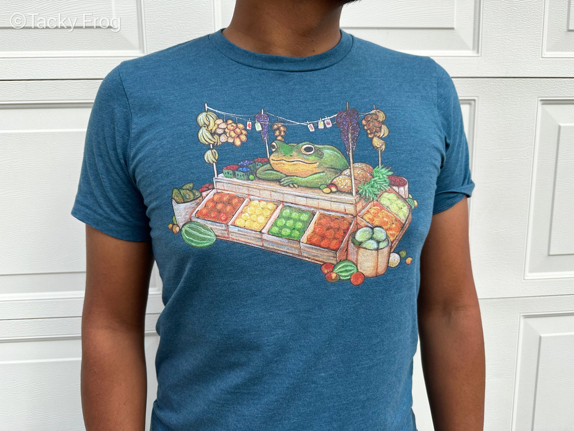 Another view of the fruit stand frog t-shirt in the color Heather Deep Teal.