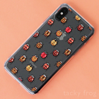 A clear phone case with a ladybug pattern on it. It is shown on an iPhone X.