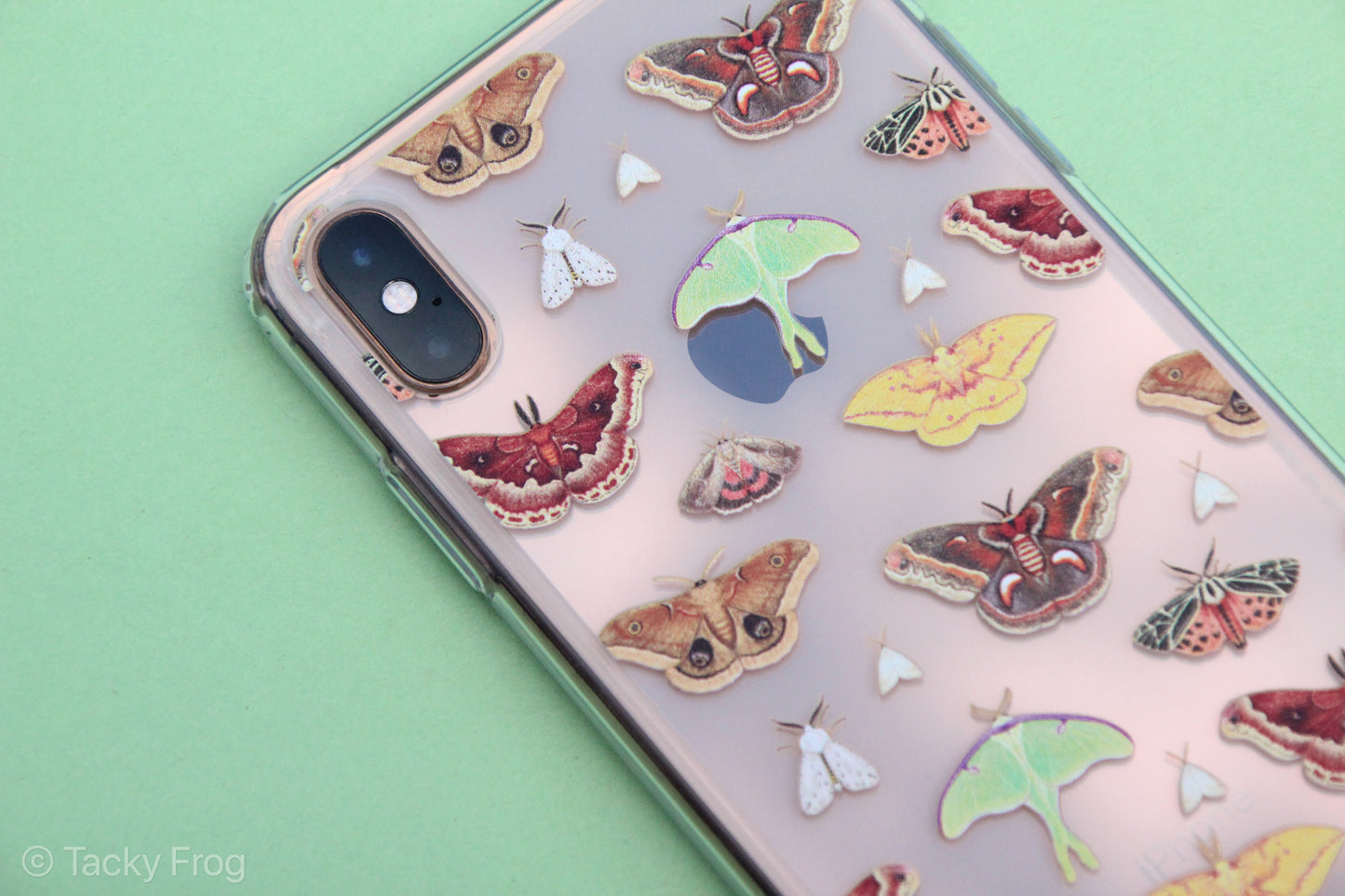 A clear phone case featuring a repeating pattern of various moths. It is shown on an iPhone XS Max. 