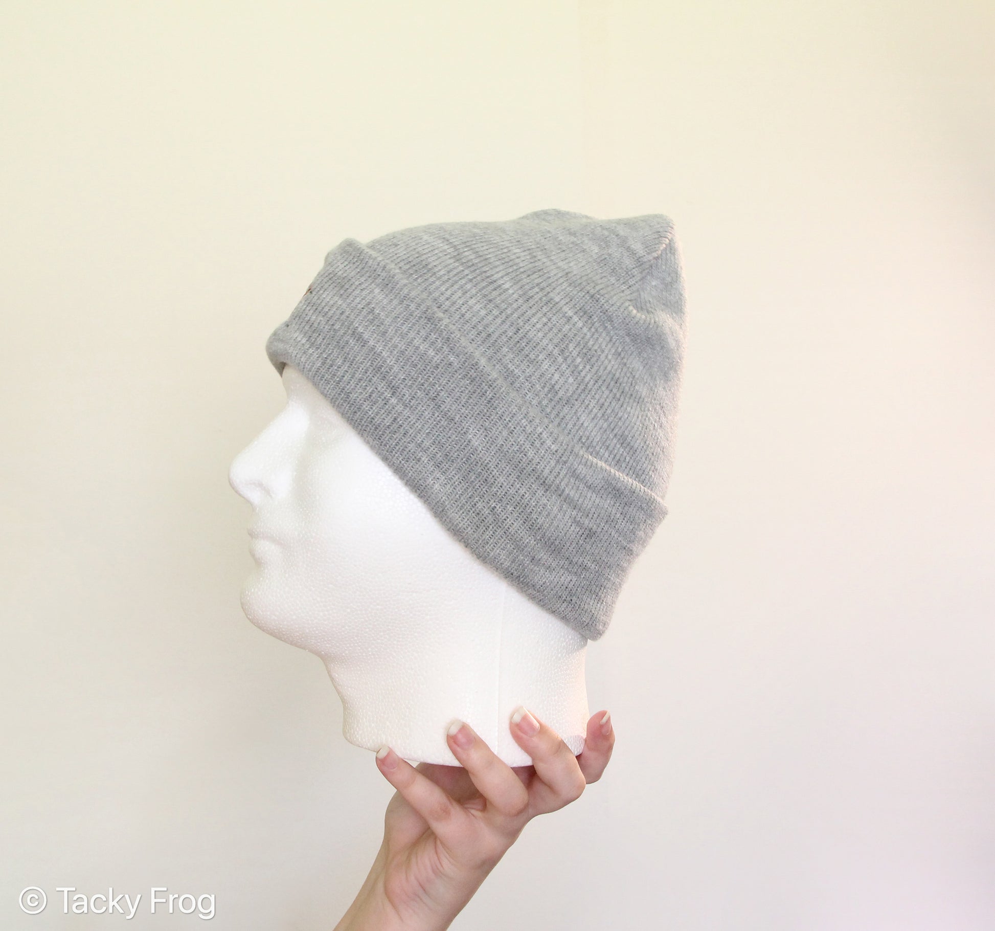 Side view fo a foam head wearing a heather grey ladybug beanie.