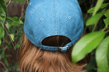 The back of a blue denim baseball cap.