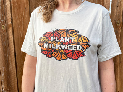 The "Plant Milkweed" monarch butterfly shirt in the "soft cream with cream text" variant.