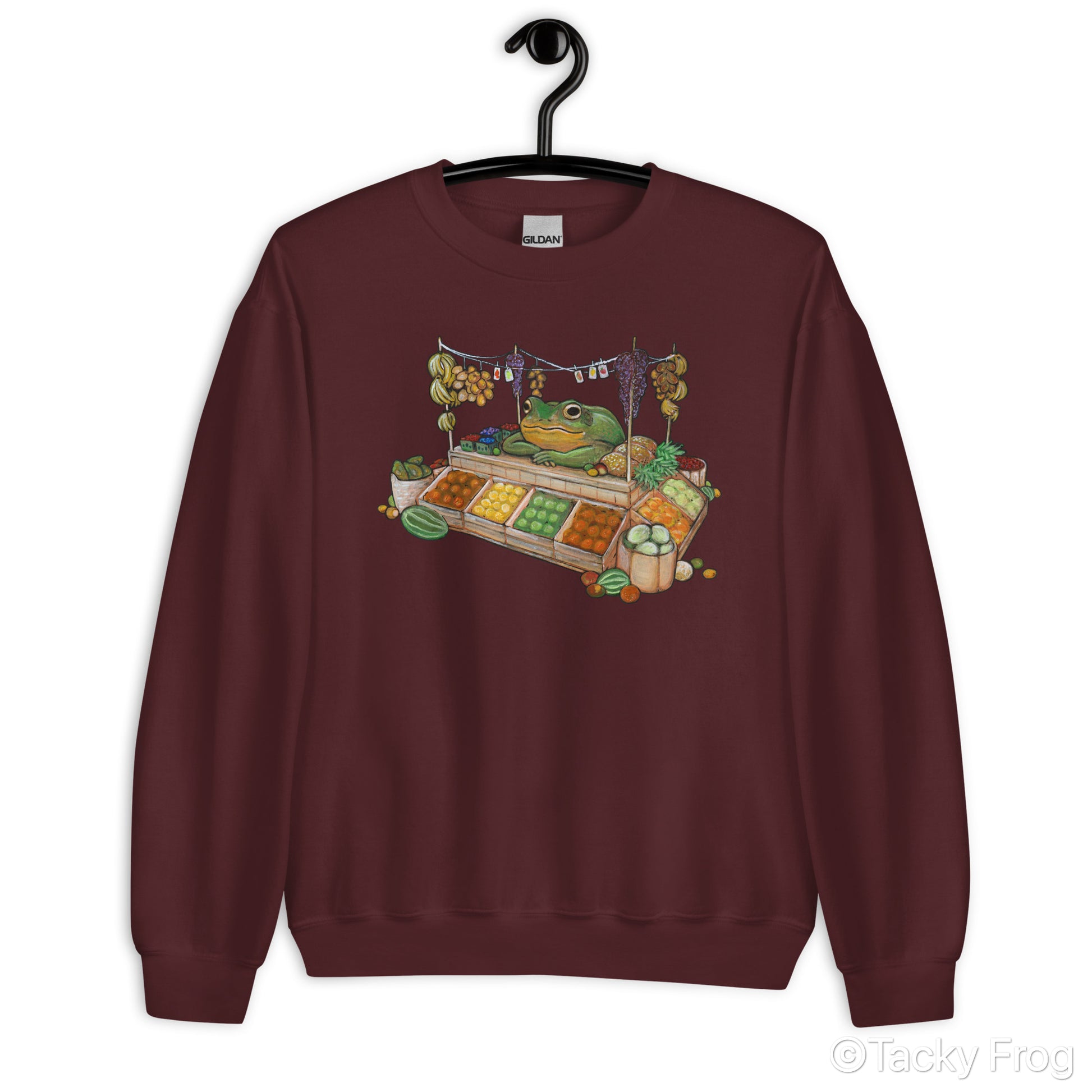 A mockup of the fruit vendor frog design on a maroon sweatshirt.