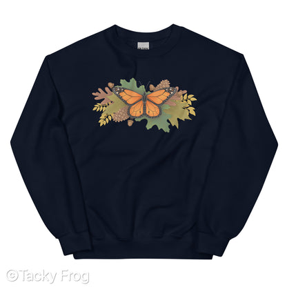 A mockup of a navy sweatshirt with a monarch butterfly and autumn leaves on it.