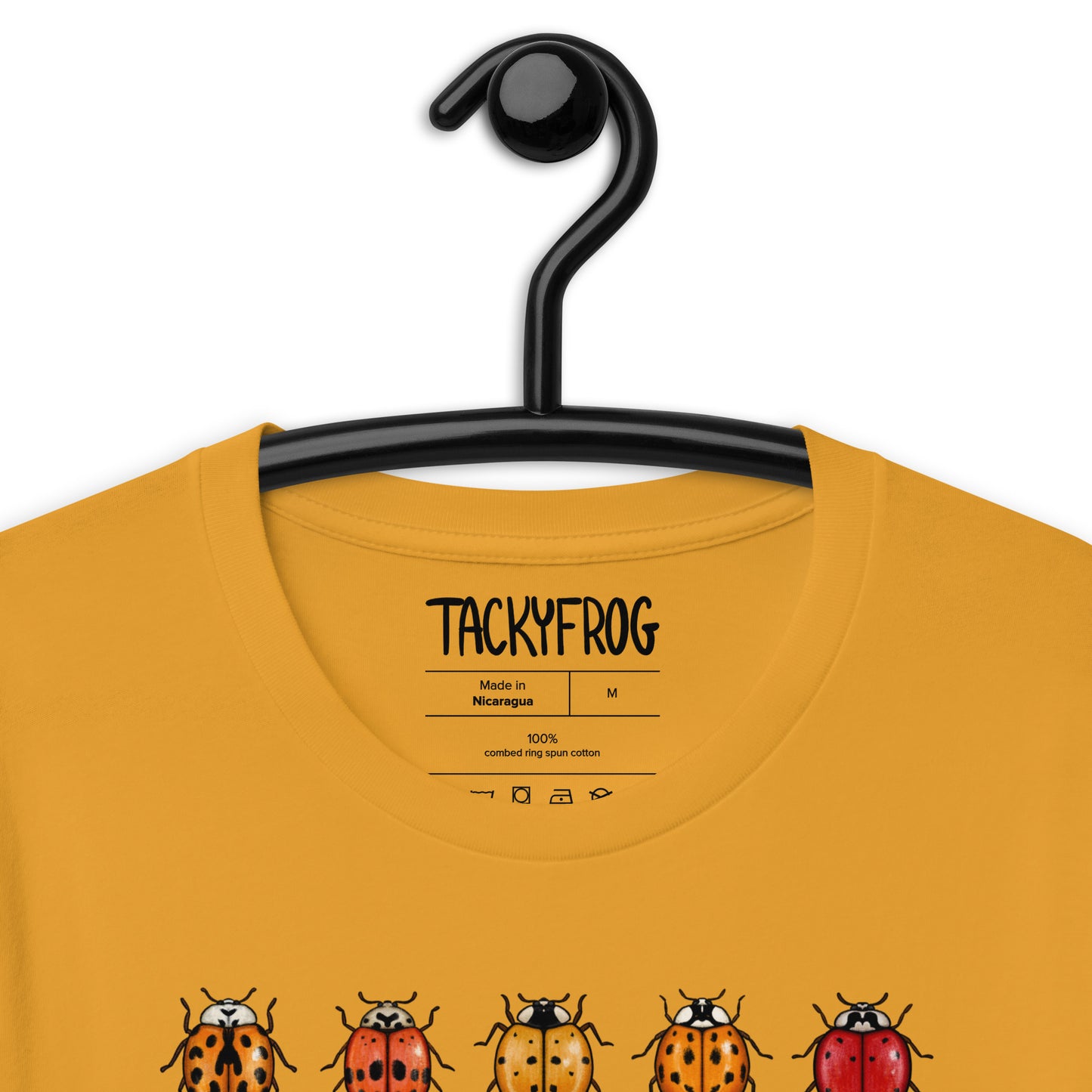 A mustard-colored mockup showing the inside label of the t-shirt