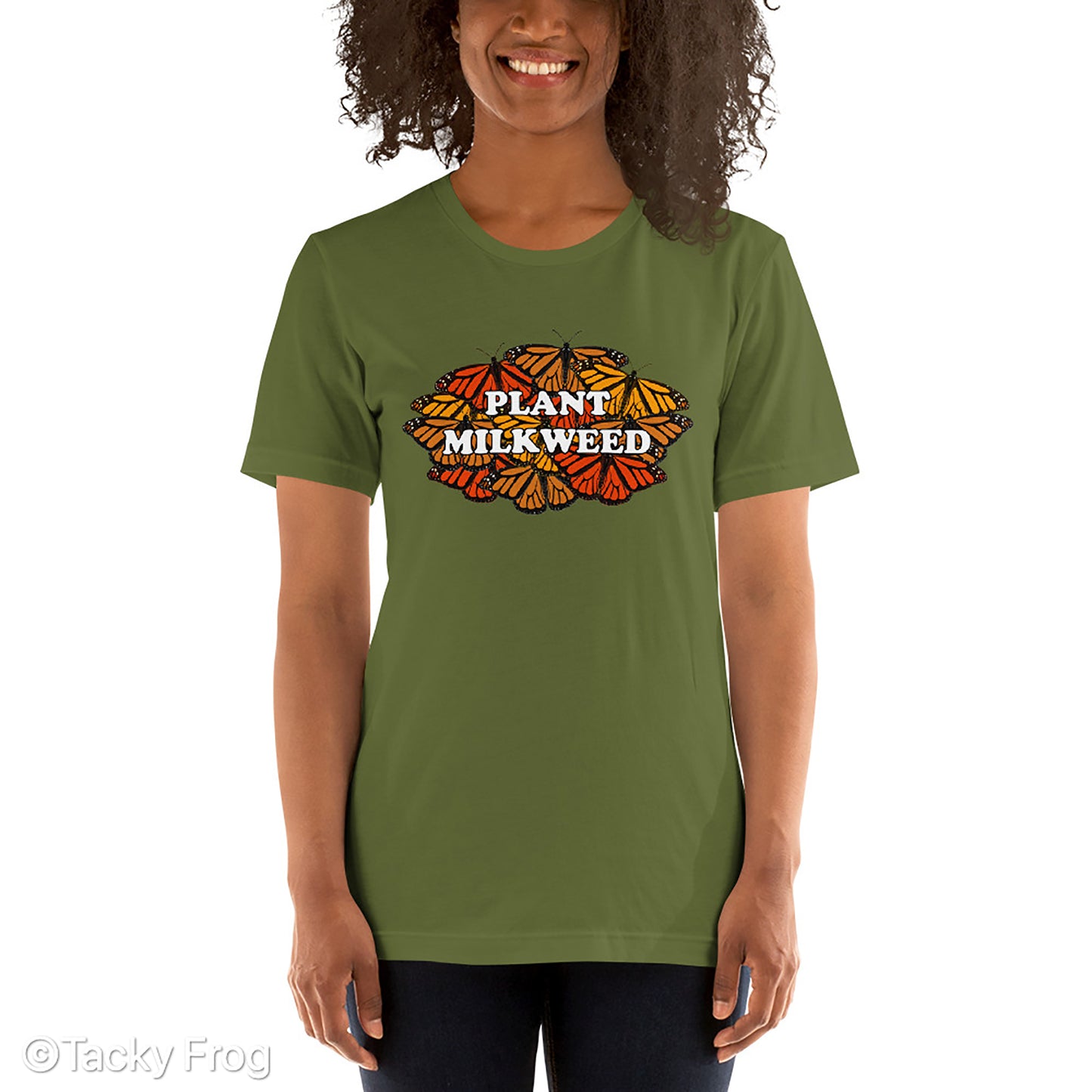 An olive-colored shirt featuring a monarch butterfly design that says "Plant Milkweed"