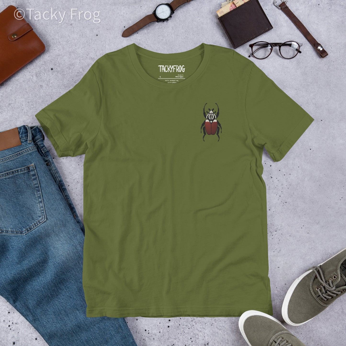 A mockup of the Goliath beetle embroidered t-shirt in the color Olive.